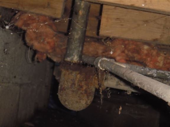 Plumbers have a bad habit of cutting floor joists that are in the way. The bathroom floor now slopes.