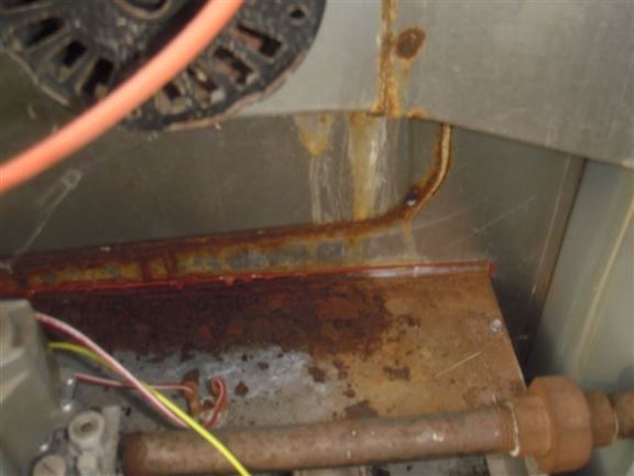 Rust inside the furnace is indicative of a blocked air conditioner drain.