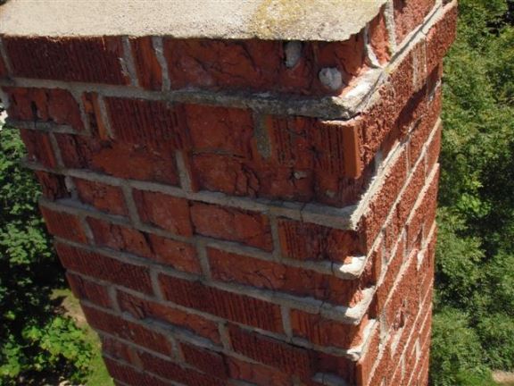 This brick chimney suffers from water damage and is beginning to crumble/spall. Soon it will need to be taken down and replaced.