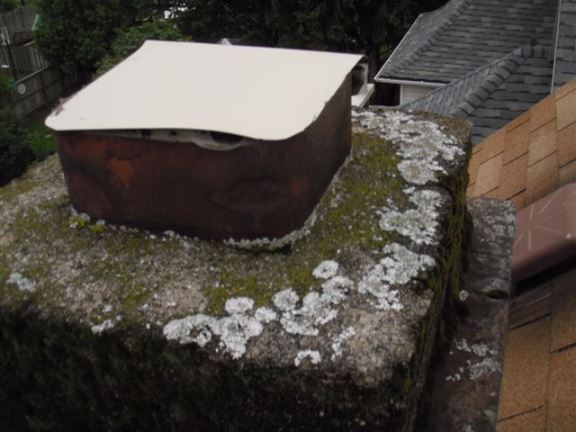 This chimney that is being used to vent the natural gas hot water heater has been capped off, resulting in dangerous carbon monoxide build up inside the house.