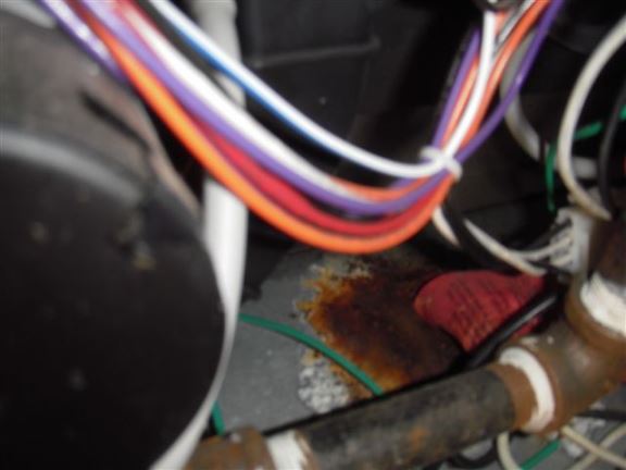 A condensate leak into a furnace is causing rust.