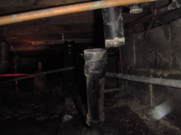 This kitchen drain pipe has become separated, causing water to drain directly into the crawl space.