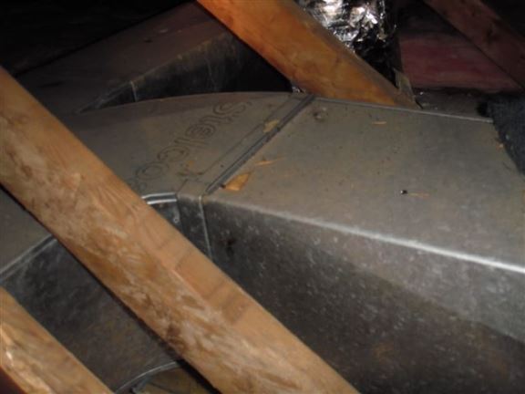This heating ductwork in an attic should be insulated for better efficiency.