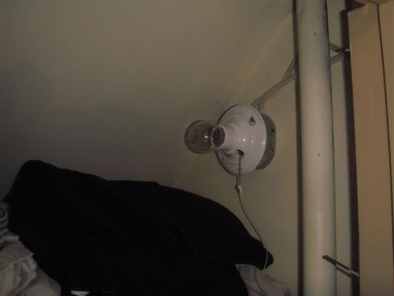 This improperly placed light in a closet is a fire hazard.