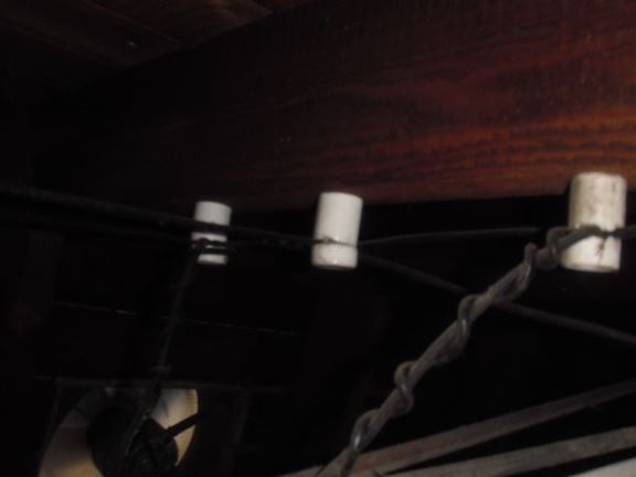 Live knob & tube wiring shown in attic indicate outdated wiring that will require replacement.