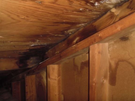 Water damage in an attic was caused by leaking chimney flashing.