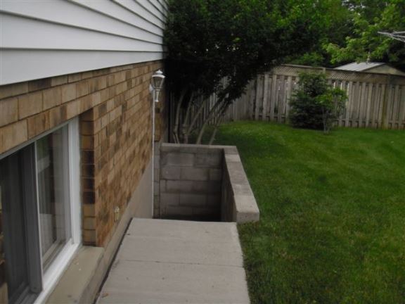 With no guard rails on this basement walk-out there is a fall hazard and risk of a law suit.