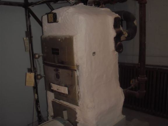 This very old boiler has an asbestos covering, but was still approved by a gas technician who tested it.