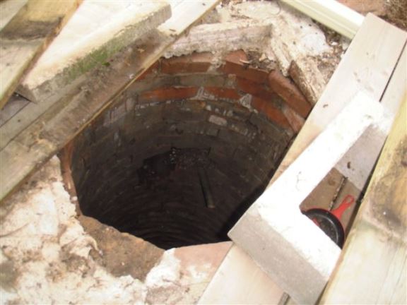 This old well without a proper cover is a safety issue.