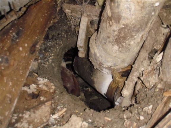 This open sewer pipe in a crawl space is pouring raw sewage on the crawl space floor.